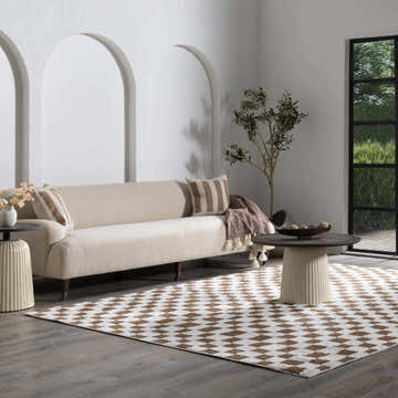 Living room scene with a brown and white checkered Keesa Area Rug, beige sofa, and modern decor. Roomscene-Rectangle
