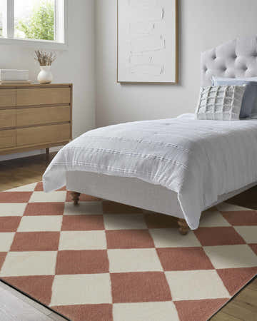 Bedroom scene with camel and pearl Almeda Diamond Washable Wool Rug. Farmhouse style with light wood dresser and gray bed. Roomscene-Rectangle