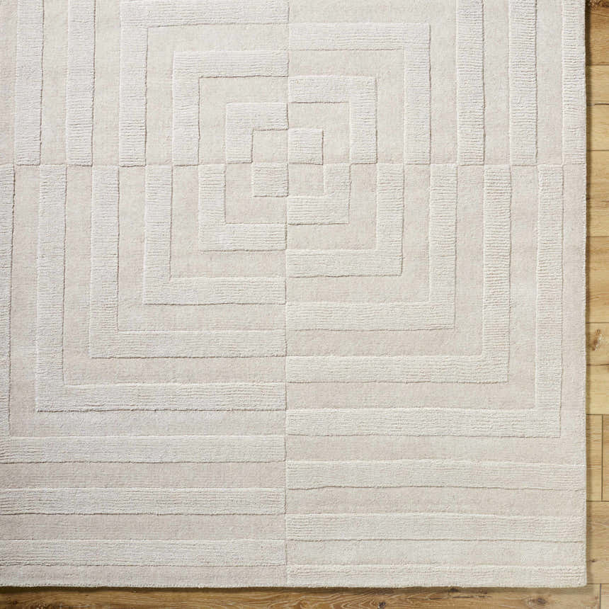 Close-up of the light silver Aretha Area Rug. Hand-loomed wool rug with a geometric square pattern and textured design. Swatch