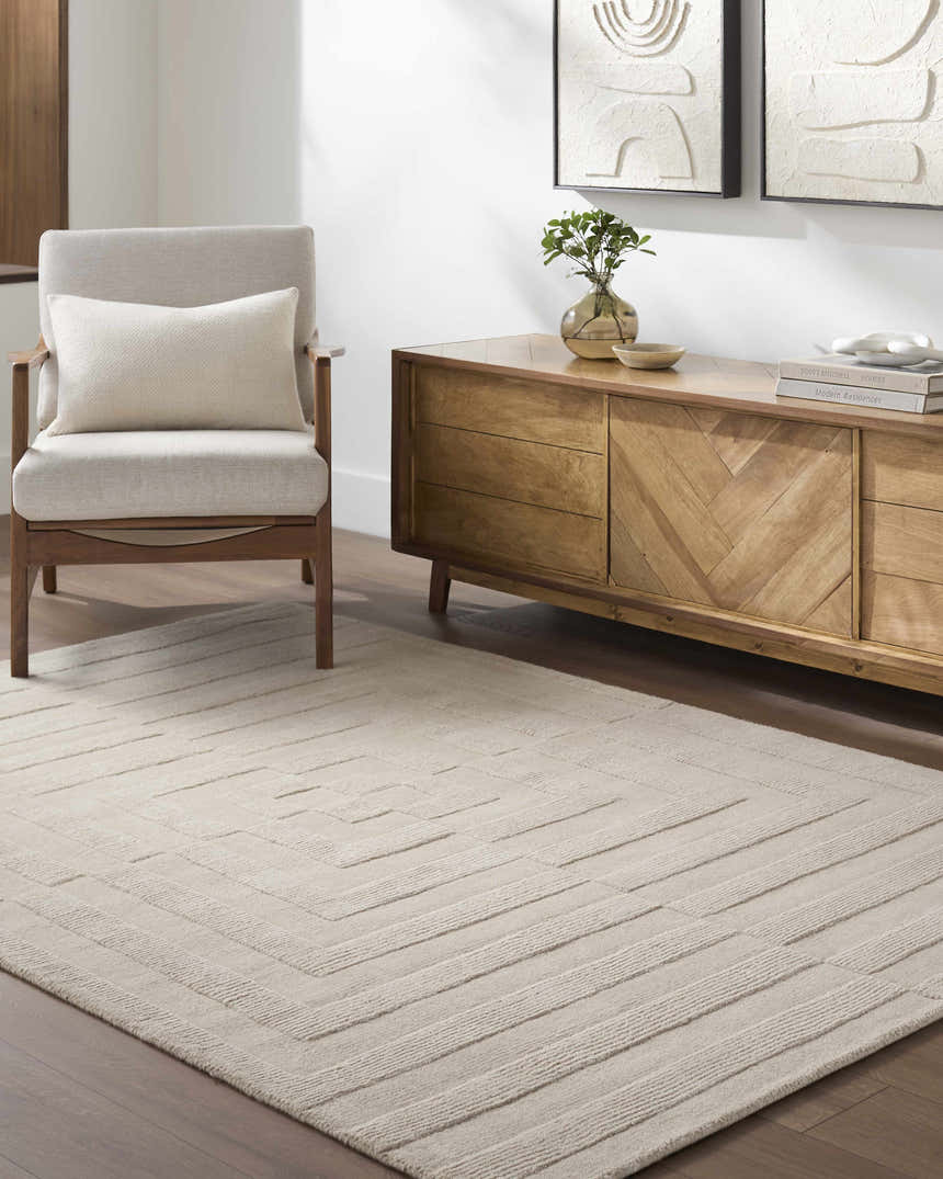 Living room scene with light silver Aretha Area Rug, wood console table, and neutral armchair. Roomscene-Rectangle