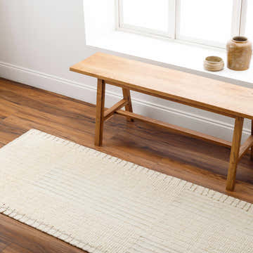 Farmhouse entryway with a wooden bench and the beige Firs Area Rug runner on wood floors. Roomscene-Runner