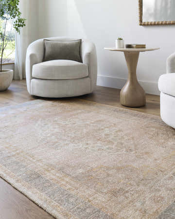 Living room scene with neutral armchairs and a tan Luciana I Traditional Medallion Area Rug on hardwood floors. Roomscene-Rectangle