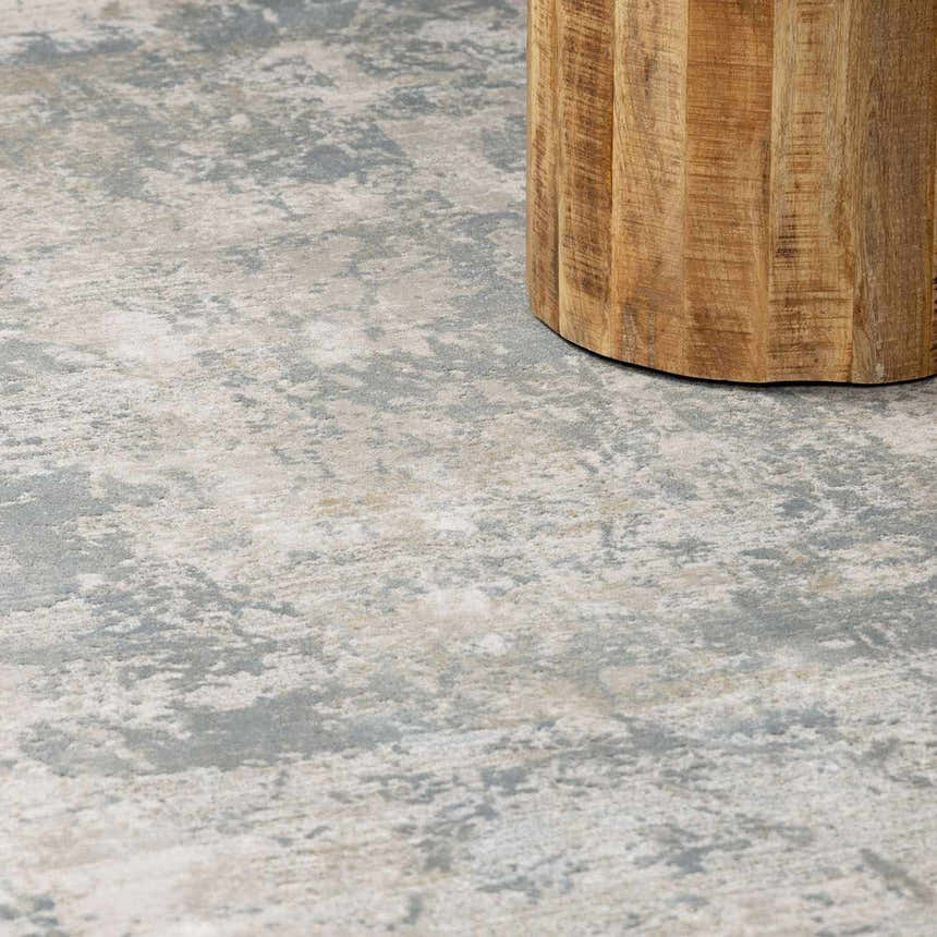 Close-up of the Fallin Gray Thick Luxe Abstract Striped Rug showing its gray, taupe, and white abstract pattern. Styleshot