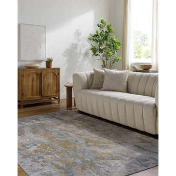 Living room scene with a beige sofa and the gray, beige Follansbee Area Rug. Roomscene-Rectangle