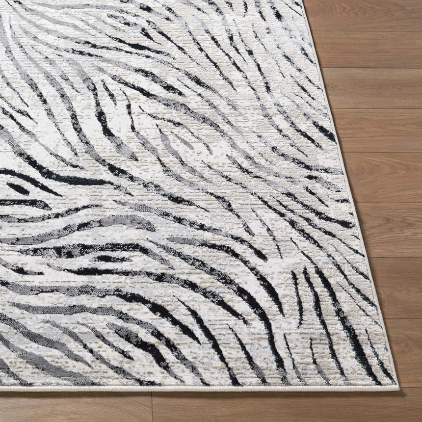Close-up of the Arlene Area Rug featuring a contemporary black, cream, and gray abstract striped design. Front