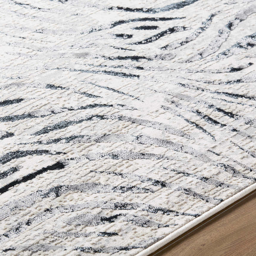 Close-up of Arlene Area Rug with black, cream, and gray abstract pattern and textured weave. Contemporary style. Texture