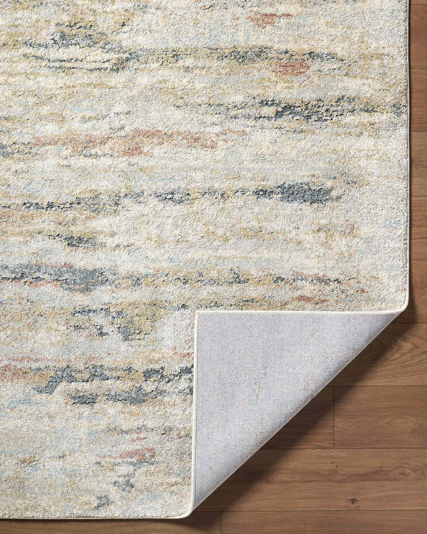 Close up of Attila Thick Luxe Area Rug showing beige, pink, gray, and tan abstract pattern and rug backing. Fold