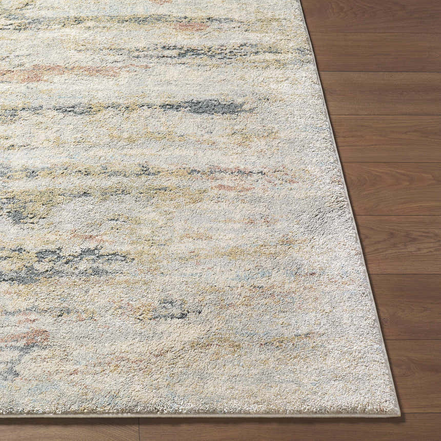 Close up of Attila Thick Luxe Area Rug showing beige, pink, gray, and teal colors on a wood floor. Front