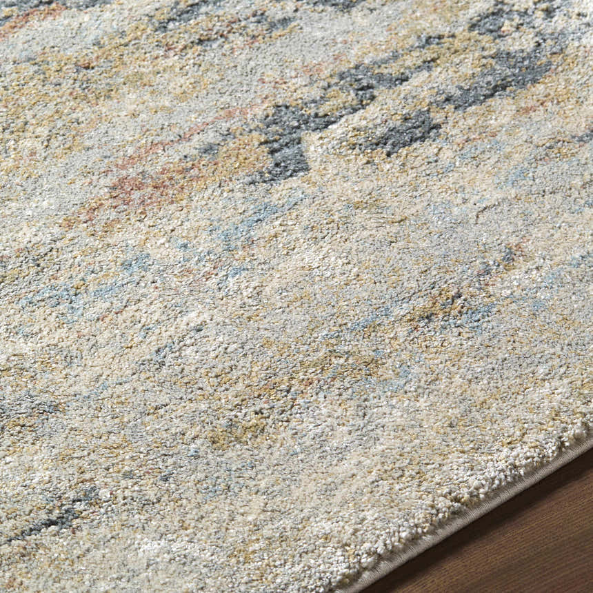 Close-up of the Attila Thick Luxe Area Rug showing beige, gray, pink, and teal abstract pattern and plush texture. Texture