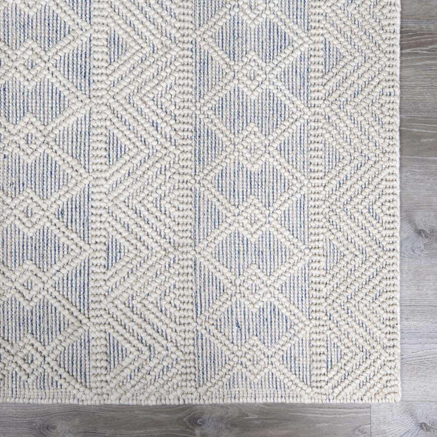 Close-up of the Ginter Handmade Beige Wool Rug showing its geometric diamond pattern and textured weave. Swatch