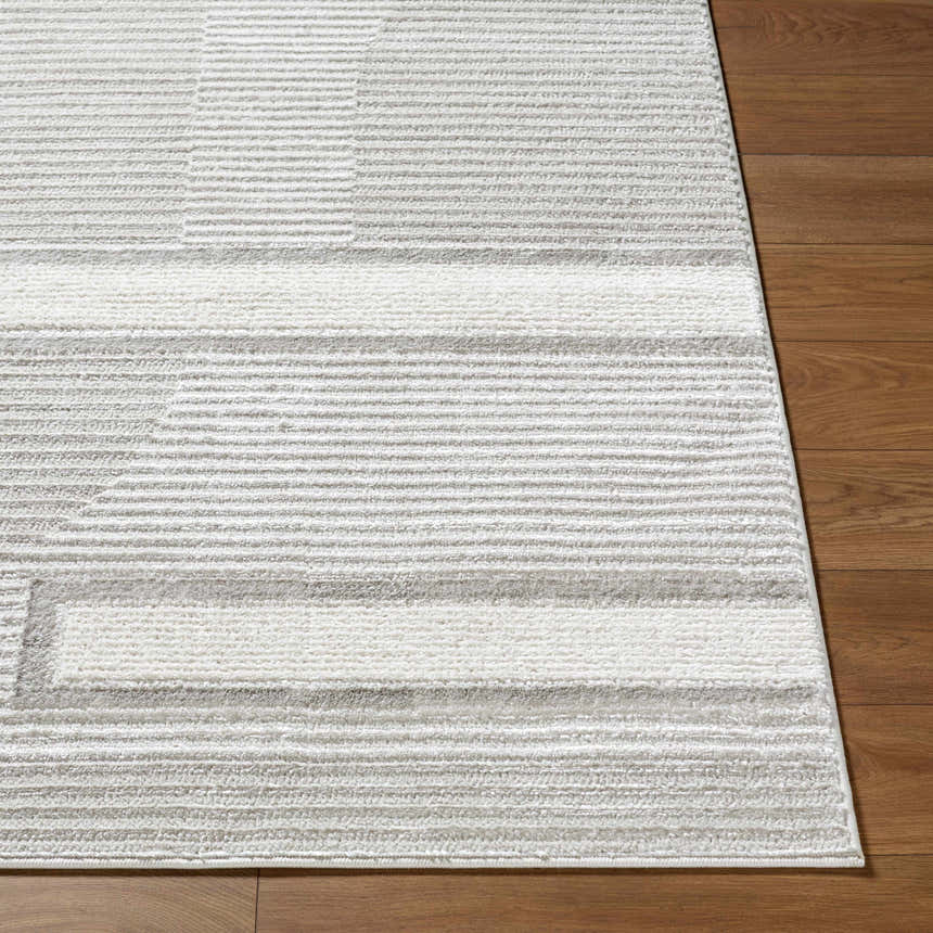 Close-up of the Atalie Area Rug showing cream, ivory, and gray horizontal stripes on a soft, textured surface. Front