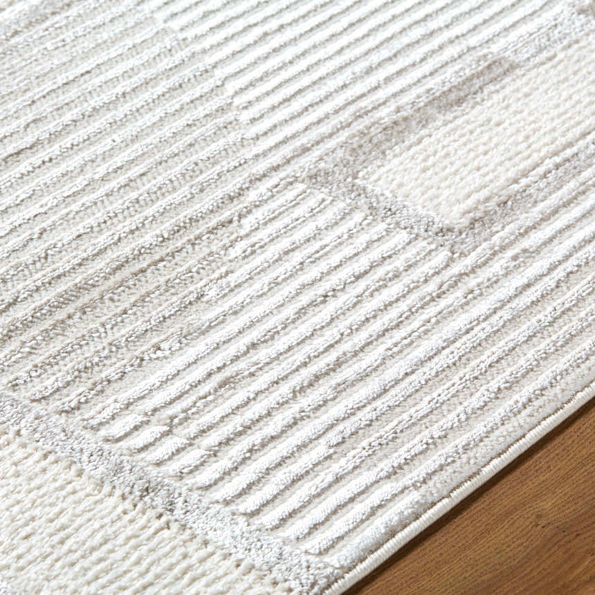 Close-up of the Atalie Area Rug featuring a contemporary cream, ivory, and light gray striped design. Texture