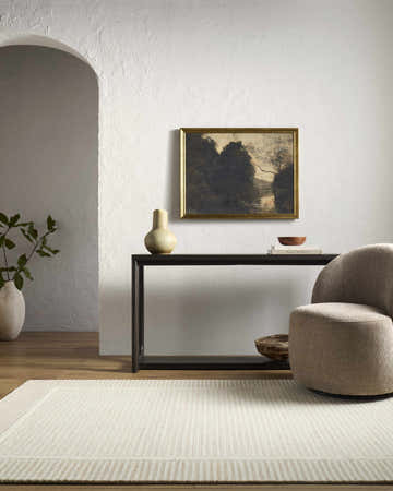 Living room scene with Hiroto Taupe area rug, console table, art, and neutral swivel chair. Farmhouse style. Roomscene-Rectangle