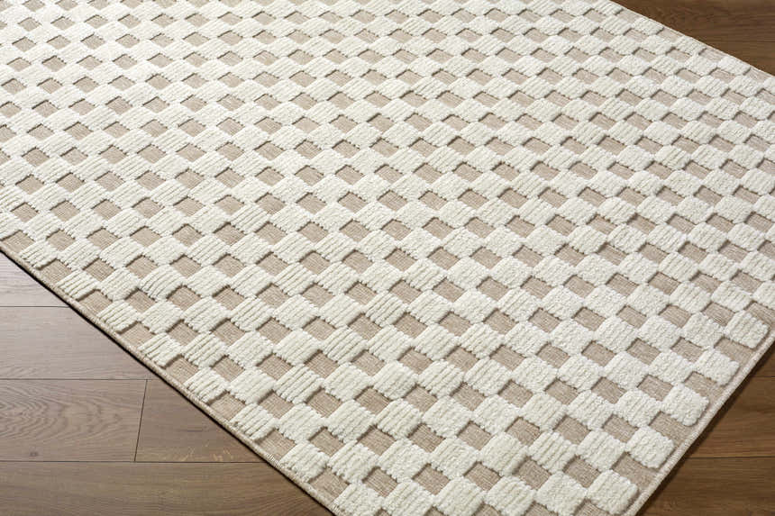 Close-up of the Anthea Light Gray Washable Area Rug. Features a woven, textured geometric pattern in light gray and white. Corner