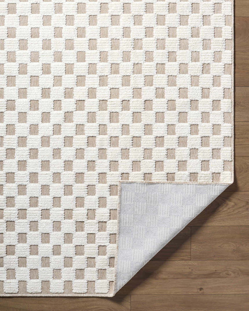 Close-up of the Anthea Light Gray Washable Area Rug. Features a textured white and light gray checkerboard pattern. Fold