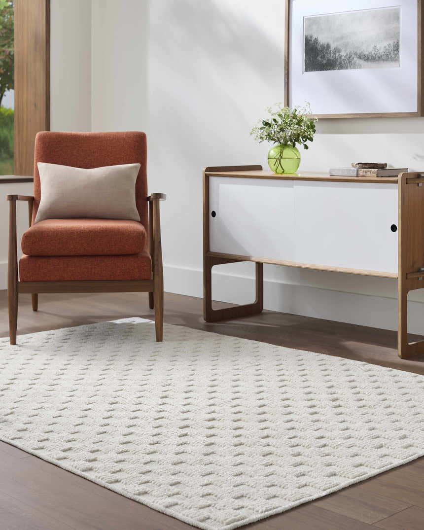 Living room scene with an Anthea Off-White 3D Checkered Washable Rug, orange chair, and white cabinet. Roomscene-Rectangle