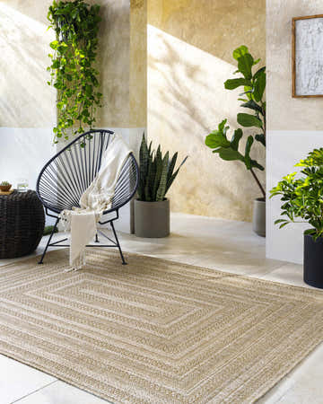 Sunlit patio scene with Avalos Brown Area Rug, modern chair, and plants creating a relaxing, neutral-toned space. Roomscene-Rectangle