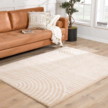 Living room scene with Allard Beige Washable Area Rug, tan sofa, and wood floors. Contemporary style. Roomscene-Rectangle