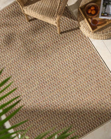 Close-up of the Ataret Burnt Sienna Area Rug, a machine-woven rug with terracotta, goldenrod, and ivory tones. Roomscene-Rectangle
