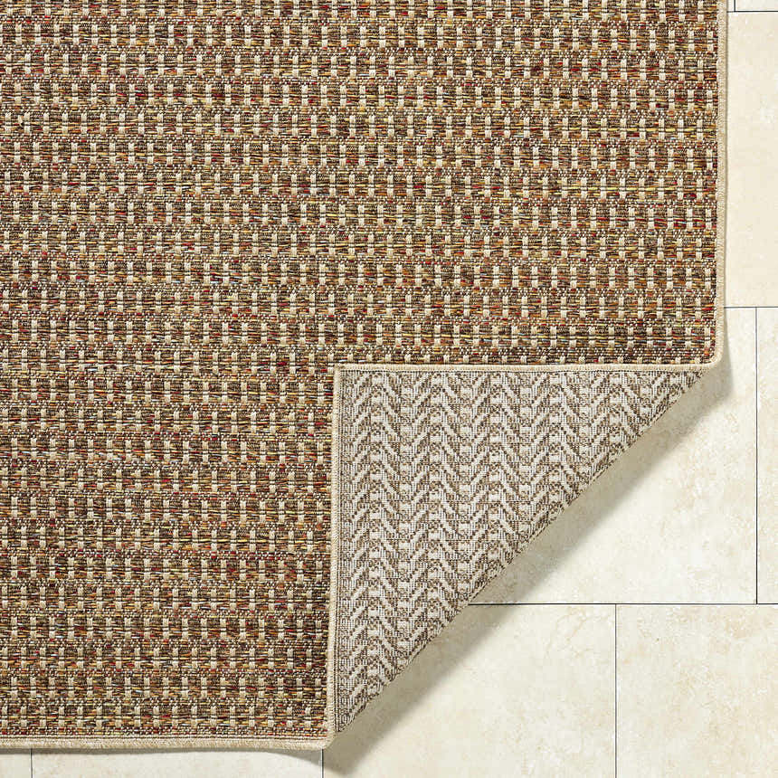 Close-up of the Ataret Burnt Sienna Area Rug showing its woven texture and colors: burnt sienna, goldenrod, ivory, and terracotta. Fold