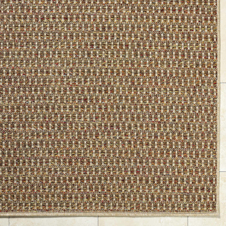 Close-up of the Ataret Burnt Sienna Area Rug. Woven texture with burnt sienna, goldenrod, ivory, and terracotta hues. Corner