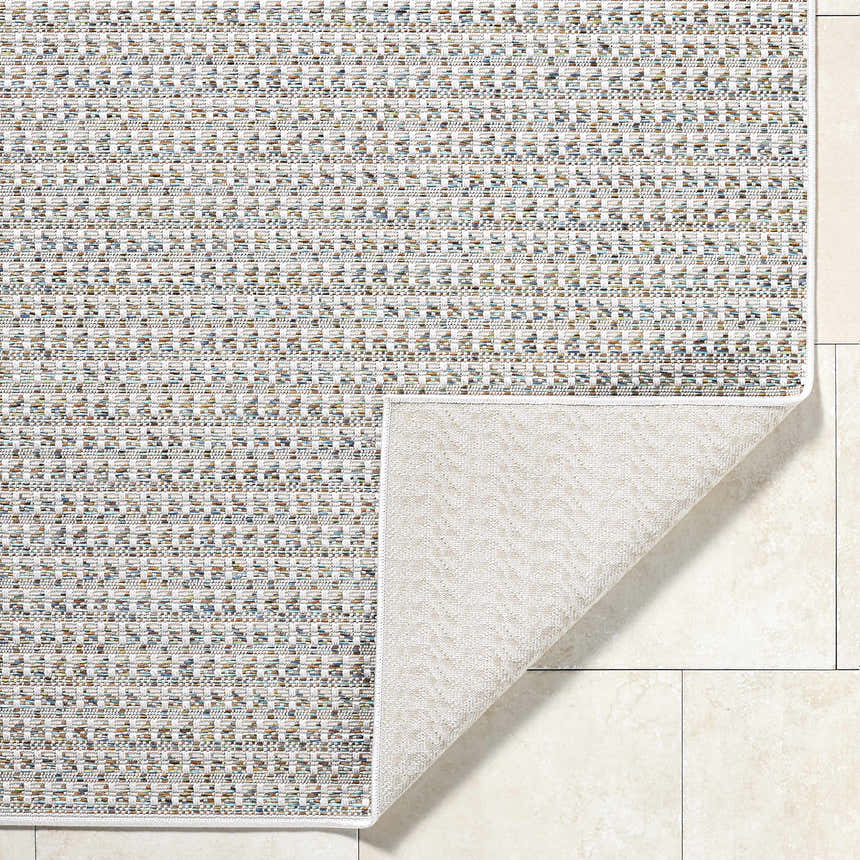 Close-up of the Ataret Ivory Area Rug showing its woven texture and colors: ivory, charcoal, blue, gray, and tan. Fold