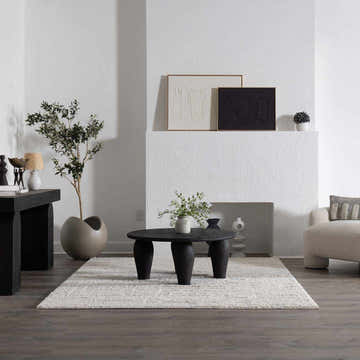 Living room scene with a cream Andia Plush Grid Rug under a black coffee table and dark wood floors. Roomscene-Rectangle