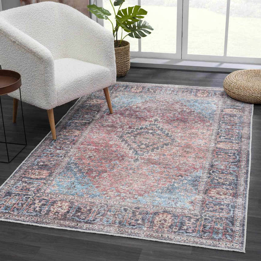Living room scene with a white chair and the Blue Burgundy Holi-2302 Washable Area Rug. Vintage style. Roomscene-Rectangle