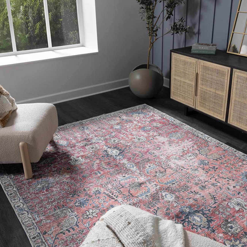 Living room scene with a Burgundy Holi-2303 Washable Area Rug, cream chair, and rattan cabinet. Vintage style with burgundy, cream, and blue tones. Roomscene-Rectangle