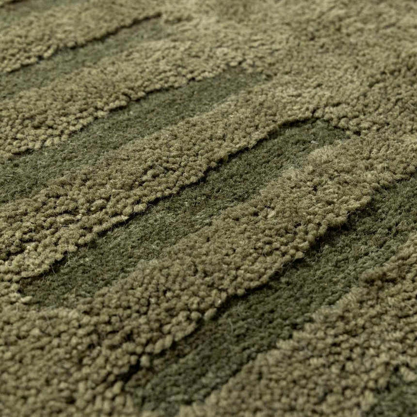 Close-up of a green Washable Wool Rug. Hand-tufted texture with stripes in prairie dust, taupe, and dark brown. Texture