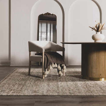 Neutral room scene with Galey Alix x Livabliss Myrtle Avenue rug, chair with tassel throw, and round wood table. Roomscene-Rectangle