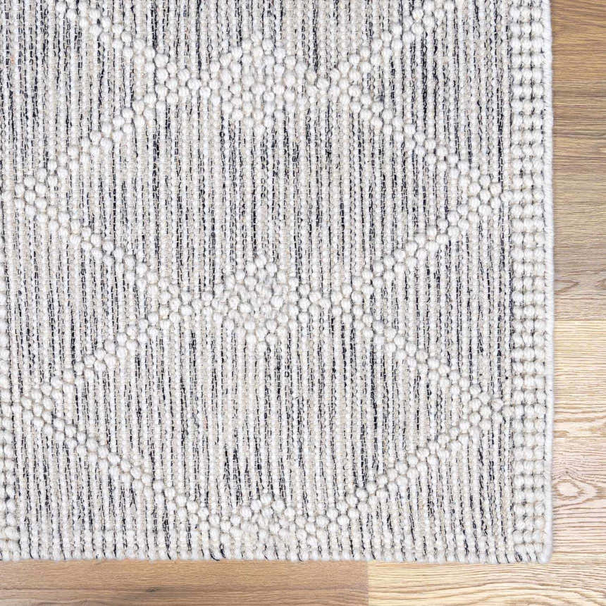 Close-up of the hand woven New Whittington Area Rug. Gray and off white geometric pattern with a farmhouse style. Swatch