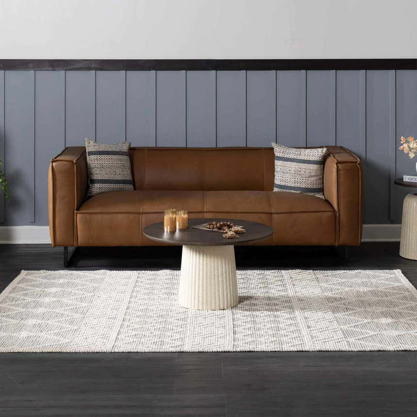 Living room scene with brown leather sofa and geometric New Whittington Area Rug in medium gray and off white. Roomscene-Rectangle