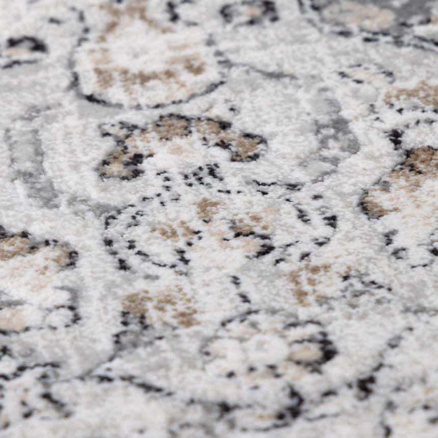 Close-up of the Parkerfield Area Rug showing its beige, black, and gray traditional vintage pattern and machine-woven texture. Texture