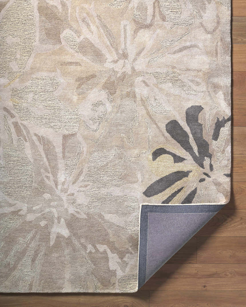Close-up of the Ilfeld Athena Gray Floral Wool Rug showing its floral pattern, texture, and backing on a wood floor. Fold