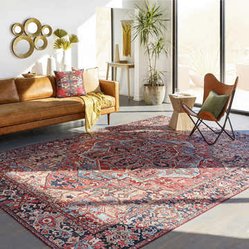 Sunlit living room with a brown leather sofa and the Livabliss Iris IRS-2330 area rug in beige, red, and navy. Roomscene-Rectangle