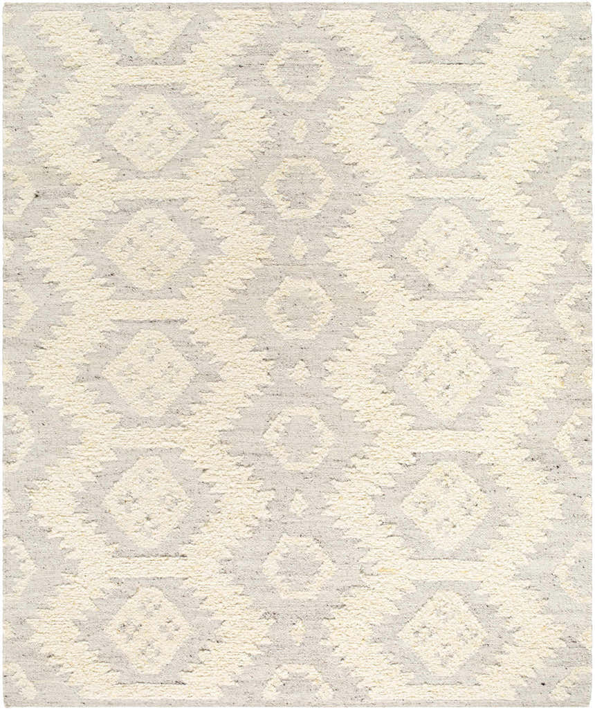 Close-up of the hand woven Jagupit Area Rug. Brown, cream, and light gray geometric pattern. 100% Wool texture. Design-Rectangle-810