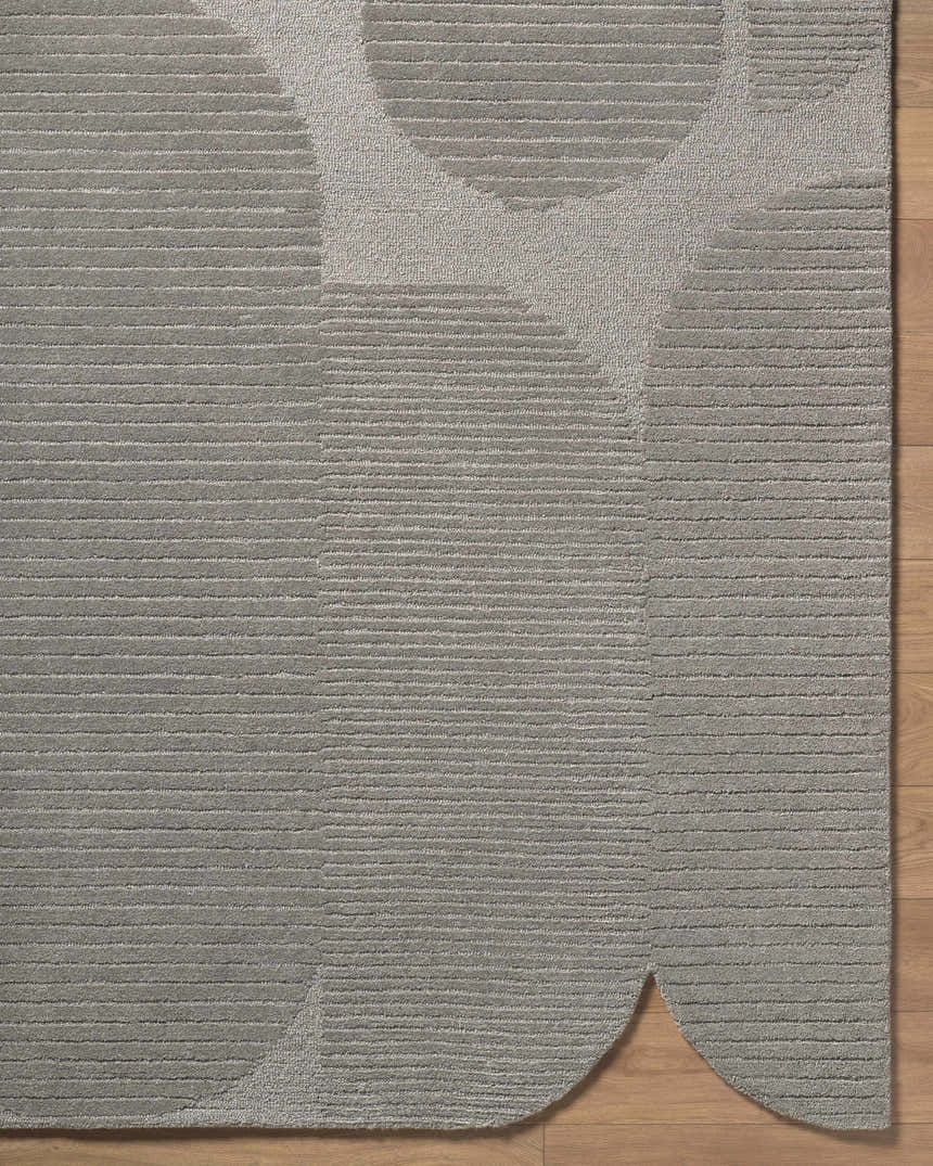 Close-up of the Fixui Gray Abstract Area Rug showing its textured, hand-tufted wool and contemporary circle design. Corner
