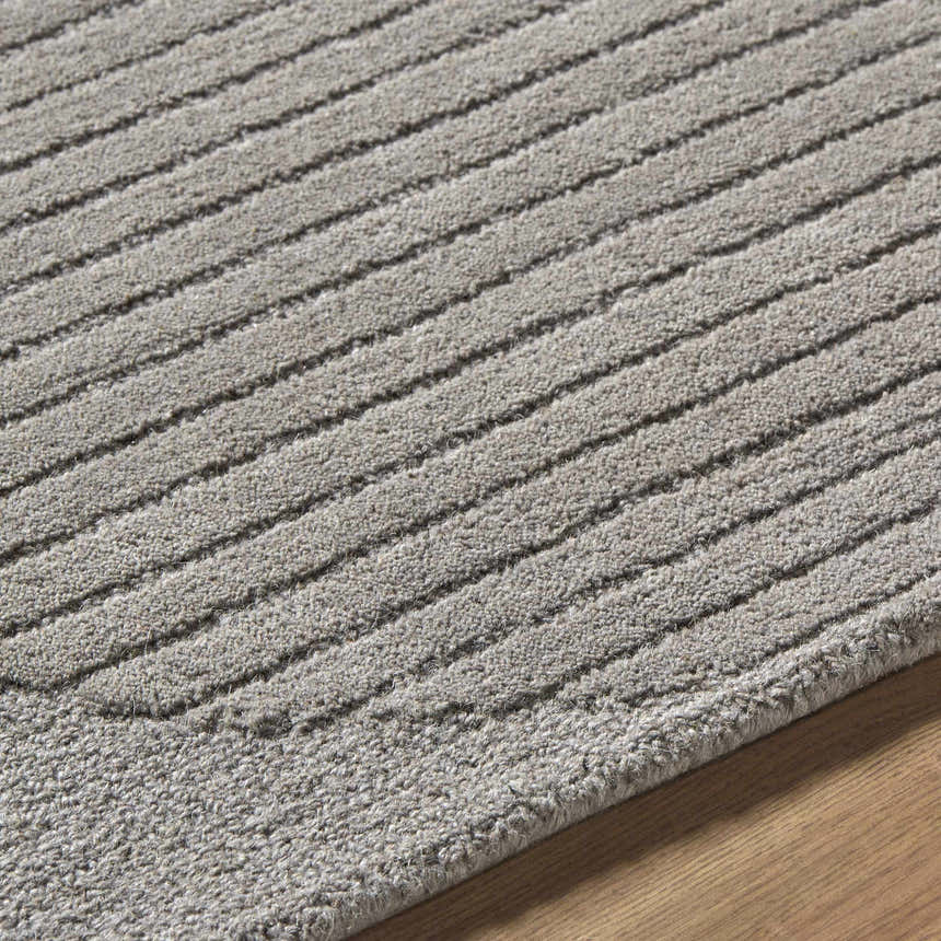 Close-up of the Fixui Gray Abstract Area Rug. Hand-tufted wool rug with a textured, striped pattern in ash gray tones. Texture