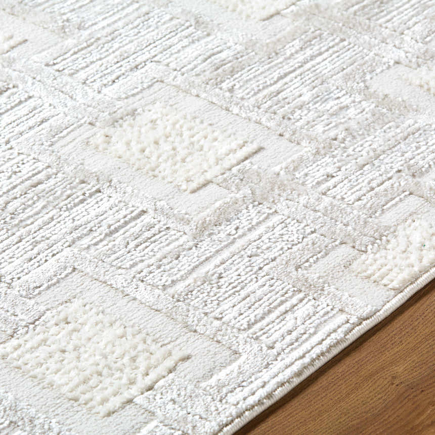 Close up of the Jackie Area Rug. Cream, ivory, and white geometric pattern with textured pile. Texture