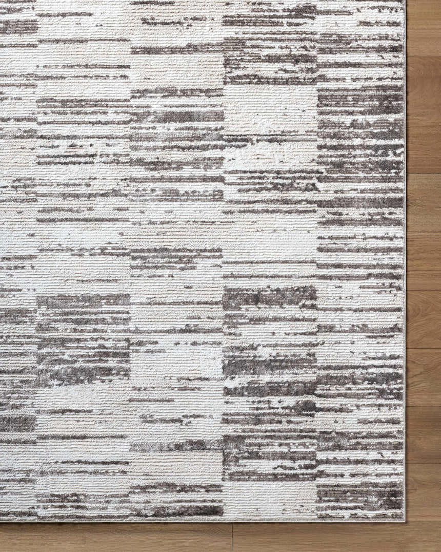 Close up of the Apphia Area Rug showing ivory and light brown horizontal stripe pattern. Corner