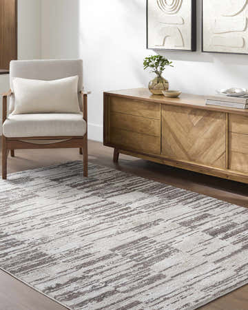 Living room scene with ivory and light brown Apphia Area Rug, light wood furniture, and neutral decor. Roomscene-Rectangle