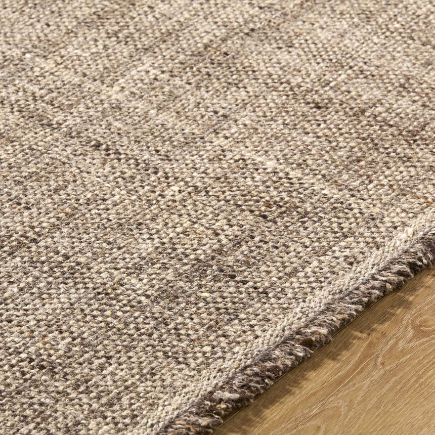 Close-up of the textured, hand woven Pufoe Modern Wool Area Rug. Neutral beige and brown tones. Texture