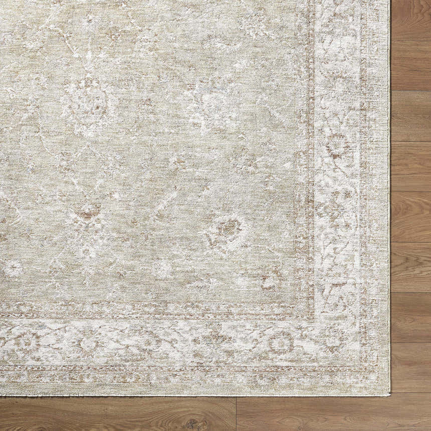 Close up of the Ashraf Area Rug showing its beige, cream, and brown traditional pattern and texture. Corner