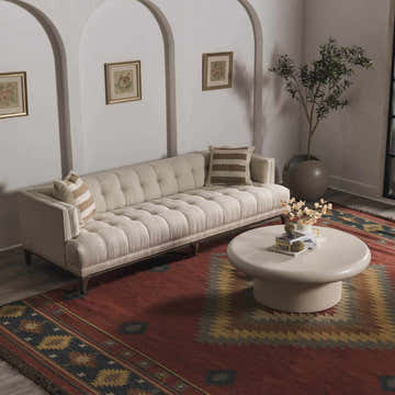 Living room with a brick red Hedon Wool Area Rug, cream sofa, round coffee table, and neutral walls. Roomscene-Rectangle