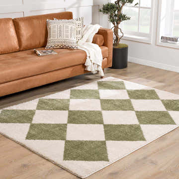 Living room scene with brown leather sofa and Arilla Green Washable Diamond Area Rug on wood floor. Roomscene-Rectangle
