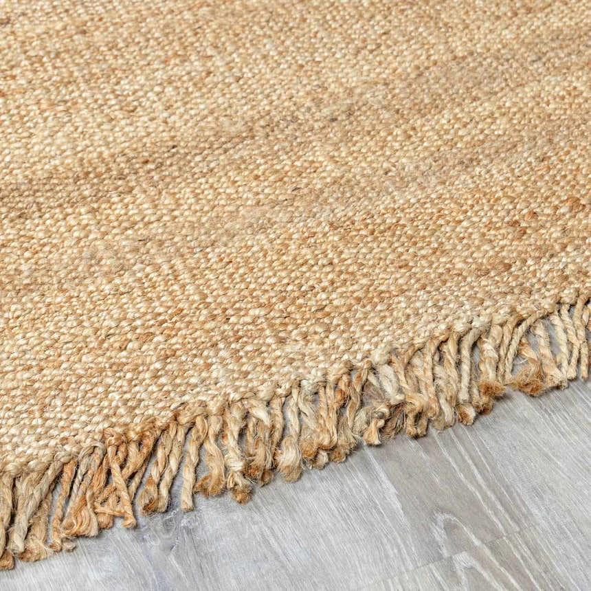 Close-up of the beige, hand-woven Oaks Perfect Flatweave Jute Rug showing texture and fringe detail. Pile