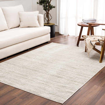 Living room scene with neutral sofa and Albena Gray area rug on dark wood floor. Roomscene-Rectangle