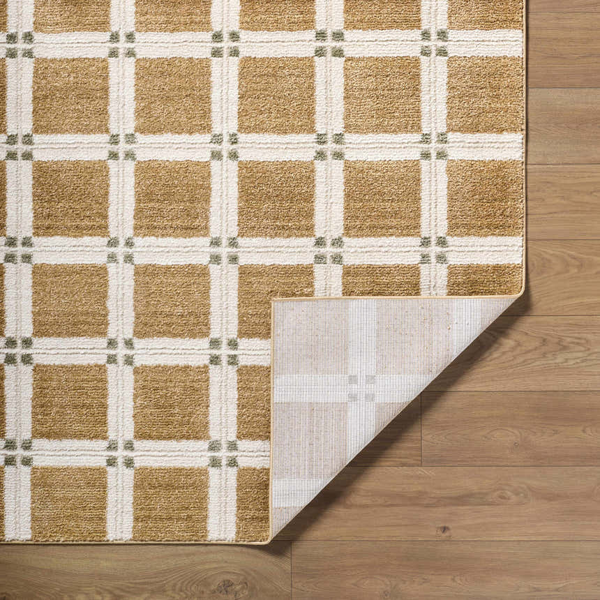 Close-up of Kalkin Light Brown Area Rug with caramel, ivory, and sage squares on wood floor. Fold