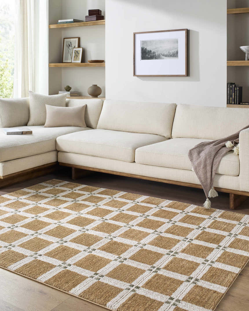Living room scene with a caramel and ivory Kalkin Light Brown Area Rug under a cream sectional sofa. Roomscene-Rectangle